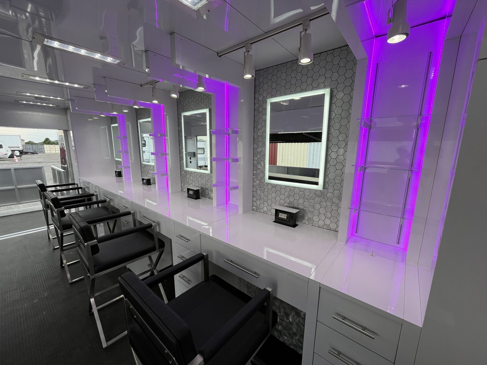 Close-up of backlit mirror station with purple accent lighting