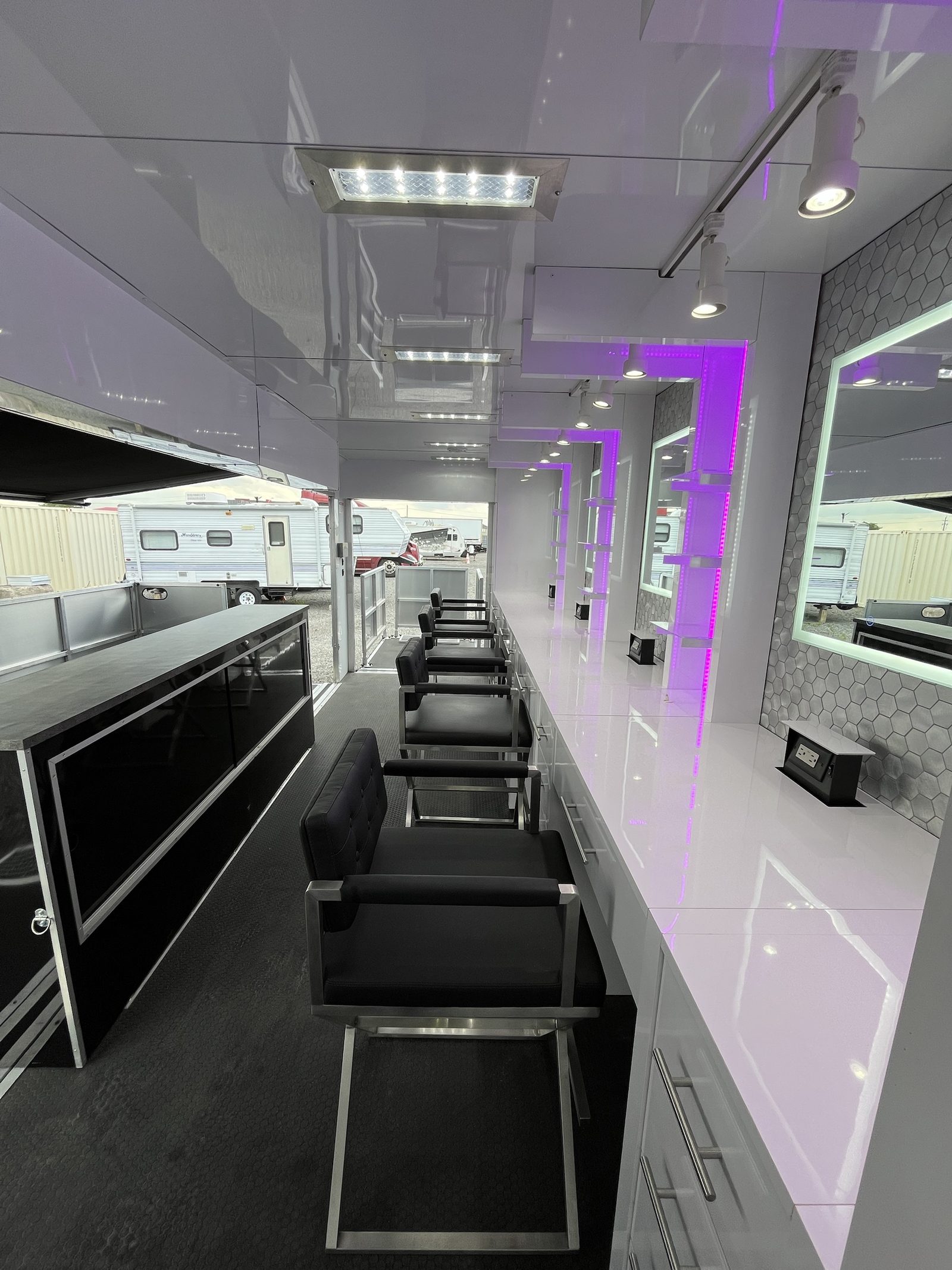 Full row of styling stations with backlit mirrors